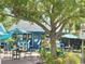 Charming storefront exterior with outdoor seating beneath colorful umbrellas, inviting customers to relax and enjoy the atmosphere at 2707 56Th S St, Gulfport, FL 33707