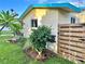 Landscaped side yard featuring lush greenery and a wooden privacy fence along the perimeter at 2707 56Th S St, Gulfport, FL 33707