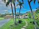 Home featuring lush tropical landscaping, a stone pathway, and solar panels at 2707 56Th S St, Gulfport, FL 33707
