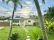 Charming single-story home featuring lush landscaping, stepping stone pathway, and freshly cut grass at 2707 56Th S St, Gulfport, FL 33707