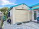 Detached garage with a pink door and awning next to an outdoor seating area at 2707 56Th S St, Gulfport, FL 33707