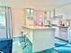 Contemporary kitchen featuring white countertops, stainless steel appliances, and a convenient breakfast bar at 2707 56Th S St, Gulfport, FL 33707