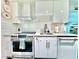 Updated kitchen showcasing stainless steel appliances, white cabinetry, and stone countertops at 2707 56Th S St, Gulfport, FL 33707
