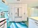Kitchen area with white cabinets, modern refrigerator, and plenty of storage space at 2707 56Th S St, Gulfport, FL 33707