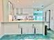 Bright kitchen with modern white cabinets, updated appliances, stylish backsplash, and counter seating at 2707 56Th S St, Gulfport, FL 33707
