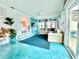 Spacious living area with stylish furniture, turquoise floors, and an open view of the kitchen at 2707 56Th S St, Gulfport, FL 33707