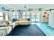 Inviting living room with a comfortable sectional sofa and view of the backyard pool through sliding glass doors at 2707 56Th S St, Gulfport, FL 33707