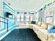 Comfortable living room with a blue accent wall, plush sectional sofa, and a view of the neighborhood at 2707 56Th S St, Gulfport, FL 33707