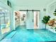Open-concept living area with access to the patio, pantry, and bathroom at 2707 56Th S St, Gulfport, FL 33707