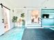 Bright living space with unique blue flooring, indoor plants, and a glimpse into the bathroom at 2707 56Th S St, Gulfport, FL 33707