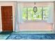 Bright living area with a wooden door, ample natural light, and decorative window treatments at 2707 56Th S St, Gulfport, FL 33707