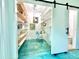 Bright pantry with open shelving, a work desk, and an adjacent bathroom at 2707 56Th S St, Gulfport, FL 33707