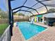 Beautiful screened-in pool area with a pool umbrella and a table with chairs at 2707 56Th S St, Gulfport, FL 33707