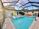 Covered in-ground pool area with a table, chairs, and a laundry room entrance at 2707 56Th S St, Gulfport, FL 33707
