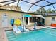 Lovely screened-in pool with in-pool seating, umbrella, and door to laundry at 2707 56Th S St, Gulfport, FL 33707