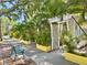 Quaint street view featuring colorful landscaping and a welcoming trellis entrance, perfect for a relaxing stroll at 2707 56Th S St, Gulfport, FL 33707