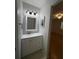 Updated bathroom with white vanity and framed mirror at 2900 Grovewood Blvd # A, Palm Harbor, FL 34683