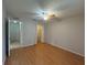 Bright bedroom featuring wood-look flooring, ceiling fan, and closet at 2900 Grovewood Blvd # A, Palm Harbor, FL 34683