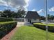 Community clubhouse with well-manicured lawn and gated entrance at 2900 Grovewood Blvd # A, Palm Harbor, FL 34683