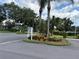 Neighborhood entrance with lush landscaping and signage at 2900 Grovewood Blvd # A, Palm Harbor, FL 34683