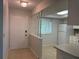 View of the entryway that transitions into the kitchen, complete with white accents at 2900 Grovewood Blvd # A, Palm Harbor, FL 34683