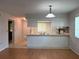 Bright kitchen with white cabinetry and a tiled backsplash, seamlessly integrated into the living space at 2900 Grovewood Blvd # A, Palm Harbor, FL 34683
