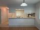 Well-lit kitchen with white cabinetry and an open design, connecting to other living areas of the home at 2900 Grovewood Blvd # A, Palm Harbor, FL 34683