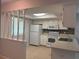 The kitchen has white appliances, tiled floors, and plentiful cabinet space at 2900 Grovewood Blvd # A, Palm Harbor, FL 34683