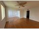 An open living room with hard surface floors, a ceiling fan, and natural lighting at 2900 Grovewood Blvd # A, Palm Harbor, FL 34683