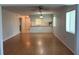 Spacious living room featuring wood floors and abundant natural light, flowing into the adjacent kitchen area at 2900 Grovewood Blvd # A, Palm Harbor, FL 34683