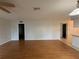Open living room featuring laminate wood flooring, natural light and a ceiling fan at 2900 Grovewood Blvd # A, Palm Harbor, FL 34683