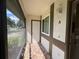 Inviting screened porch with neutral tones, tiled flooring, and natural light at 2900 Grovewood Blvd # A, Palm Harbor, FL 34683