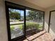 Screened porch showcasing a view of the street and landscaping at 2900 Grovewood Blvd # A, Palm Harbor, FL 34683