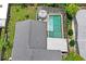 This aerial shows a well-maintained private pool, a tidy backyard, and a durable roof at 3113 Chamblee Ln, Clearwater, FL 33759