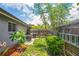 This is a tranquil backyard with a lawn, mature trees, and privacy fencing create a serene outdoor oasis at 3113 Chamblee Ln, Clearwater, FL 33759