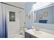 A recently renovated bathroom features blue walls, and a single sink vanity with modern fixtures at 3113 Chamblee Ln, Clearwater, FL 33759