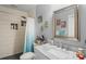 Bathroom with marble countertop and shower over tub with tiled surround at 3113 Chamblee Ln, Clearwater, FL 33759