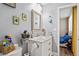 Bright bathroom with marble countertop, toilet and doorway to bedroom at 3113 Chamblee Ln, Clearwater, FL 33759