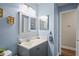 A charming bathroom features a vanity with a sleek countertop, modern fixtures, and a framed mirror at 3113 Chamblee Ln, Clearwater, FL 33759