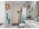 Bathroom featuring tiled shower over tub with a built-in toiletry shelf at 3113 Chamblee Ln, Clearwater, FL 33759
