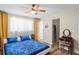 Bedroom with wood-look floors and an open doorway to a closet and vanity area at 3113 Chamblee Ln, Clearwater, FL 33759