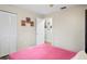 A bedroom showcases hardwood floors, neutral paint, and a closet with sliding louvered doors at 3113 Chamblee Ln, Clearwater, FL 33759