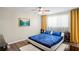 Cozy bedroom with wood-look floors, ceiling fan, and bright natural light at 3113 Chamblee Ln, Clearwater, FL 33759