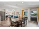 Open dining area with dining set, hardwood floors, and view to kitchen, living room and outside patio at 3113 Chamblee Ln, Clearwater, FL 33759