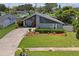 Charming two-story home featuring a well-manicured lawn and unique nautical decor at 3113 Chamblee Ln, Clearwater, FL 33759