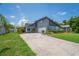 Charming two-story home featuring a well-manicured lawn and a driveway with curb appeal at 3113 Chamblee Ln, Clearwater, FL 33759