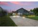 Home with a nautical theme, beautiful landscaping, a welcoming entrance, and a long driveway at 3113 Chamblee Ln, Clearwater, FL 33759