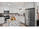 Modern kitchen with white cabinetry, granite countertops, stainless steel appliances, and decorative island at 3113 Chamblee Ln, Clearwater, FL 33759