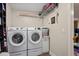 Laundry room featuring modern Samsung washer and dryer set and shelving units at 3113 Chamblee Ln, Clearwater, FL 33759