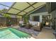 This spacious patio with comfortable seating is perfect for relaxing and enjoying a covered pool view at 3113 Chamblee Ln, Clearwater, FL 33759